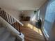 Corner view of the open living room showcasing a fireplace, staircase, and hardwood floors at 1063 Riverbend Club Se Dr, Atlanta, GA 30339