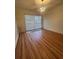 Bright living room featuring wood floors, sliding glass doors and modern lighting fixture at 1063 Riverbend Club Se Dr, Atlanta, GA 30339