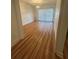 Bright living room featuring wood floors, sliding glass doors and modern lighting fixture at 1063 Riverbend Club Se Dr, Atlanta, GA 30339