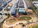 Aerial view of homes surrounding scenic pond, tennis court, green space, and walking paths at 13 Ganel Ln, Alpharetta, GA 30009