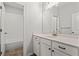 Bright bathroom featuring a white vanity with a large mirror, complemented by tile floors at 13 Ganel Ln, Alpharetta, GA 30009