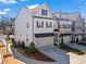 New construction townhome with a brick and siding exterior, two-car garage, and professionally landscaped front yard at 13 Ganel Ln, Alpharetta, GA 30009