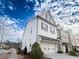 Beautiful three-story townhome featuring a two-car garage, brick exterior, and well-maintained landscaping at 13 Ganel Ln, Alpharetta, GA 30009