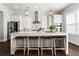 Modern kitchen with white cabinets, stainless steel appliances, and a large island with seating at 13 Ganel Ln, Alpharetta, GA 30009