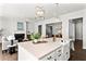 Open-concept kitchen featuring an island with sink and seating, open to the living room and fireplace at 13 Ganel Ln, Alpharetta, GA 30009