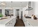 Bright, modern kitchen features white cabinetry, stainless steel appliances, and a large island with a farmhouse sink at 13 Ganel Ln, Alpharetta, GA 30009