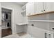 A well-organized laundry room with storage cabinets, shelving, and laundry sink at 13 Ganel Ln, Alpharetta, GA 30009