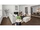 Open-concept living room view showcasing fireplace, seating, and dining area with chandelier at 13 Ganel Ln, Alpharetta, GA 30009