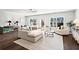 Spacious living room with modern decor, large windows, and dark hardwood floors at 13 Ganel Ln, Alpharetta, GA 30009