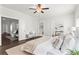 Bright main bedroom with neutral tones, ceiling fan, hardwood floors, and connected sitting room and bathroom at 13 Ganel Ln, Alpharetta, GA 30009