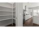 Walk-in pantry featuring ample shelving space, providing plenty of room for storage at 13 Ganel Ln, Alpharetta, GA 30009