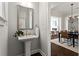 Elegant powder room featuring pedestal sink, modern fixtures, and neutral paint at 13 Ganel Ln, Alpharetta, GA 30009