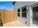 Outdoor deck with a wooden privacy screen featuring an entrance door and grey siding at 1745 Lansmere Sw St, Marietta, GA 30008