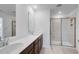 Bathroom with double vanity, granite counters, tile flooring, and a glass-enclosed shower at 1745 Lansmere Sw St, Marietta, GA 30008