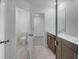 Bright bathroom featuring double vanity sinks, tile floors, and access to the toilet and closet at 1745 Lansmere Sw St, Marietta, GA 30008