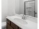 Bathroom featuring a modern vanity, sleek faucet, a framed mirror, and a walk-in shower at 1745 Lansmere Sw St, Marietta, GA 30008