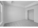 Bedroom with neutral carpet and white walls, featuring windows and a closet at 1745 Lansmere Sw St, Marietta, GA 30008