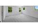 Spacious bedroom with neutral carpet, three windows, and white walls offering ample natural light at 1745 Lansmere Sw St, Marietta, GA 30008