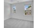 Bedroom featuring neutral carpet, two windows, and views of the surrounding neighborhood at 1745 Lansmere Sw St, Marietta, GA 30008