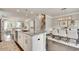 Open-concept kitchen with a granite island, stainless steel appliances, and adjacent dining area at 1745 Lansmere Sw St, Marietta, GA 30008