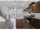 Open kitchen with a granite island, modern appliances, stainless steel fixtures, and wood flooring at 1745 Lansmere Sw St, Marietta, GA 30008