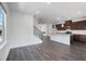 Sunlit living room with hardwood floors, a cozy fireplace, and a stylish open-concept design at 1745 Lansmere Sw St, Marietta, GA 30008