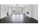 Bright living room with hardwood floors, modern fireplace, open layout, and access to kitchen at 1745 Lansmere Sw St, Marietta, GA 30008
