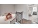 Elegant stairway landing with decorative artwork, leading to a primary bedroom at 1745 Lansmere Sw St, Marietta, GA 30008
