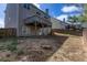 Fenced backyard with grass, gravel patio, and two-story home with walkout basement at 203 Overlook Ct, Dallas, GA 30157