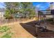 Fenced backyard with grass, gravel patio, and space for gardening at 203 Overlook Ct, Dallas, GA 30157