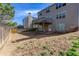 Fenced backyard with grass, gravel patio, and two-story home at 203 Overlook Ct, Dallas, GA 30157