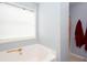 Clean bathroom featuring a white tub, window, and neutral walls, creating a serene and functional space at 203 Overlook Ct, Dallas, GA 30157