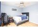 Bedroom features a neutral color scheme, wood flooring and a cozy gray bed frame with a blue patterned blanket at 203 Overlook Ct, Dallas, GA 30157