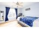 Bright bedroom with wood floors, blue walls, a ceiling fan and natural light streaming through the window at 203 Overlook Ct, Dallas, GA 30157