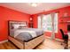 Inviting bedroom with a tufted headboard, a large window, and wood floors, perfect for relaxation at 203 Overlook Ct, Dallas, GA 30157