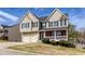 Lovely two-story home with well-maintained landscaping, brick porch, and a convenient two-car garage at 203 Overlook Ct, Dallas, GA 30157
