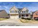 Attractive two-story home with vinyl siding, brick accents, covered porch, and a two-car garage at 203 Overlook Ct, Dallas, GA 30157