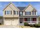 Charming two-story home with a two-car garage, covered front porch, and manicured landscaping at 203 Overlook Ct, Dallas, GA 30157