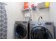 Laundry room features front load washer and dryer, plus storage shelves for added convenience and organization at 203 Overlook Ct, Dallas, GA 30157