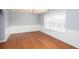 Spacious living room featuring hardwood floors, natural light, and elegant wainscoting at 203 Overlook Ct, Dallas, GA 30157