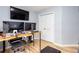Well-lit office space featuring modern desks, dual monitors, and hardwood flooring at 203 Overlook Ct, Dallas, GA 30157