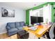 Comfortable office area featuring a blue couch, a wooden desk, and ample natural light at 203 Overlook Ct, Dallas, GA 30157