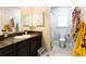 Bathroom with a vanity, sink, mirror, toilet, and shower with yellow bath robe at 35 Rock Rose Dr, Covington, GA 30014