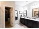 Well lit bathroom featuring black cabinets, and walk-in closet at 35 Rock Rose Dr, Covington, GA 30014