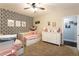 Bedroom with two beds, patterned accent wall, and a white six drawer dresser at 35 Rock Rose Dr, Covington, GA 30014