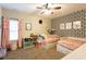 Bedroom featuring patterned accent wall, two beds, window, and storage baskets at 35 Rock Rose Dr, Covington, GA 30014