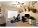 Bedroom featuring multiple deer heads on the wall, a desk and a window at 35 Rock Rose Dr, Covington, GA 30014