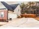 Side view of a home featuring a large garage and driveway with a basketball area at 35 Rock Rose Dr, Covington, GA 30014