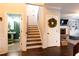 Hallway view with stairs, half-bathroom, and access to the living room with fireplace and built-in shelving at 35 Rock Rose Dr, Covington, GA 30014