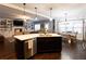 Open kitchen with island and breakfast bar, stainless appliances, and seamless transition to living and dining areas at 35 Rock Rose Dr, Covington, GA 30014